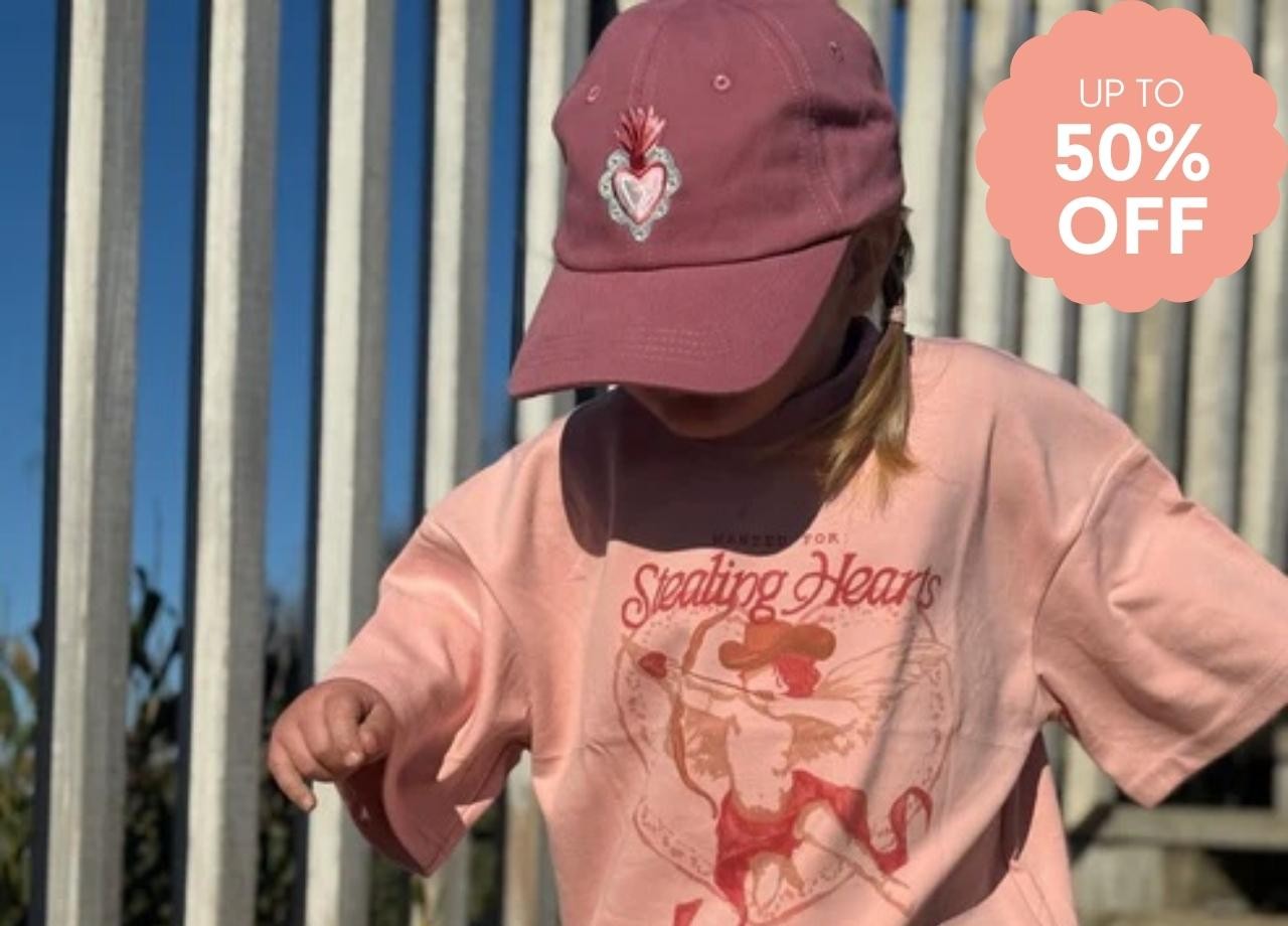 A girl wearing a pink tshirt and cap