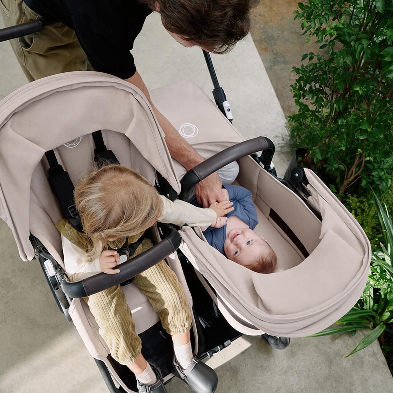 A mum with her baby and toddler in the Bugaboo Donkey 6 double pram in Australia