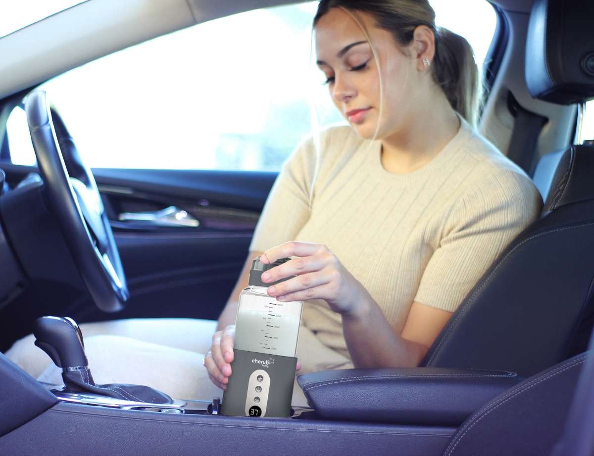 A mum using her cherub baby bottle warmer in the car