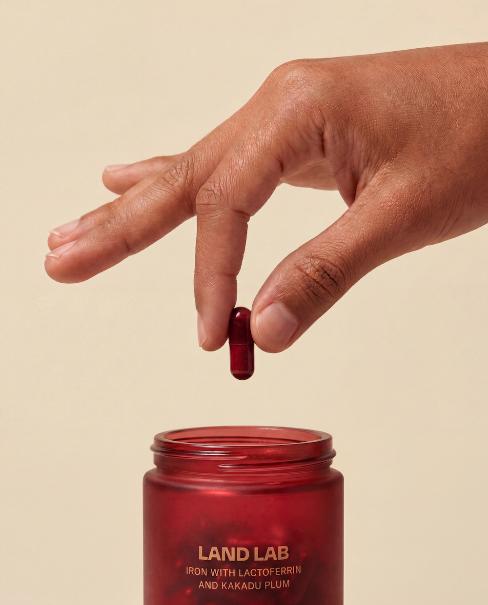 a woman picking up a land lab pregnancy iron supplement