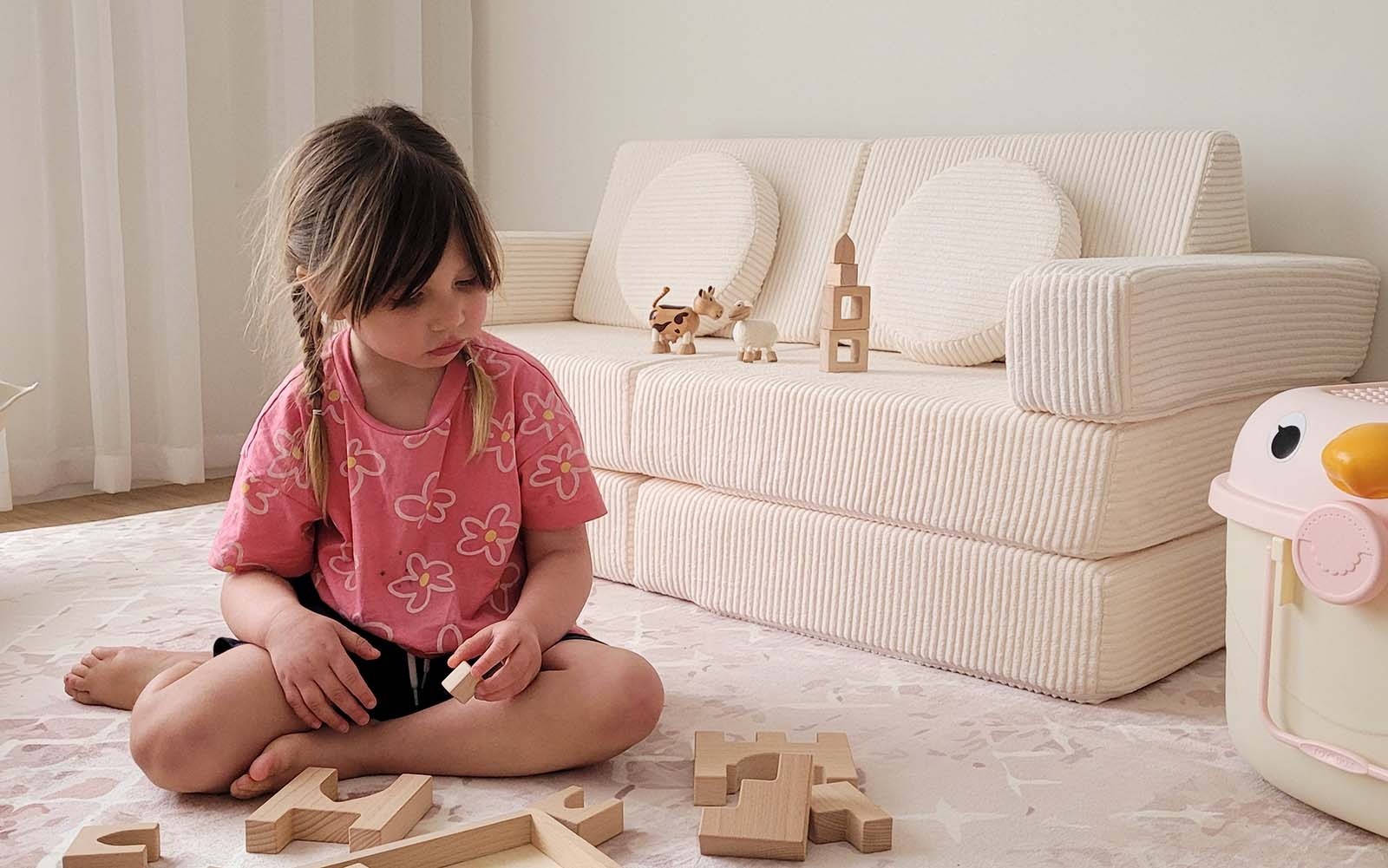 A child next to a mini play couch in Australia