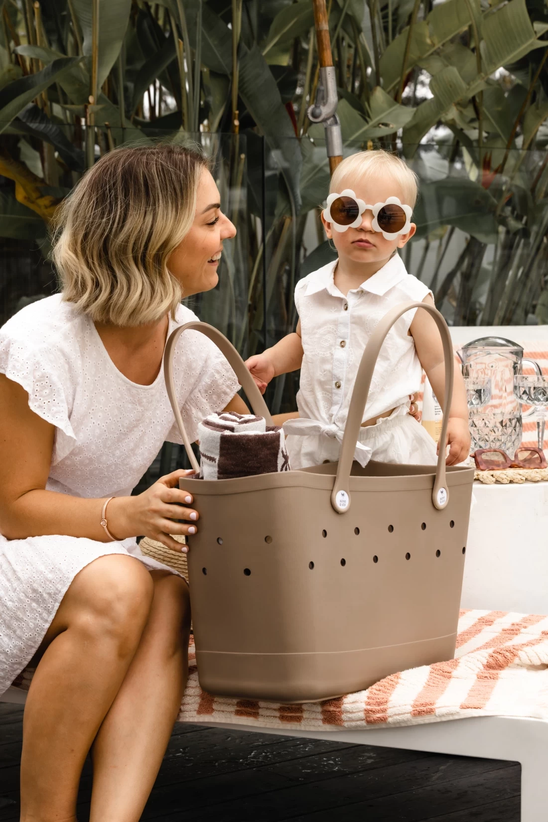 Mum sitting with her daughter beside her while holding an everyday bag – the best Mothers Day gift for mums.