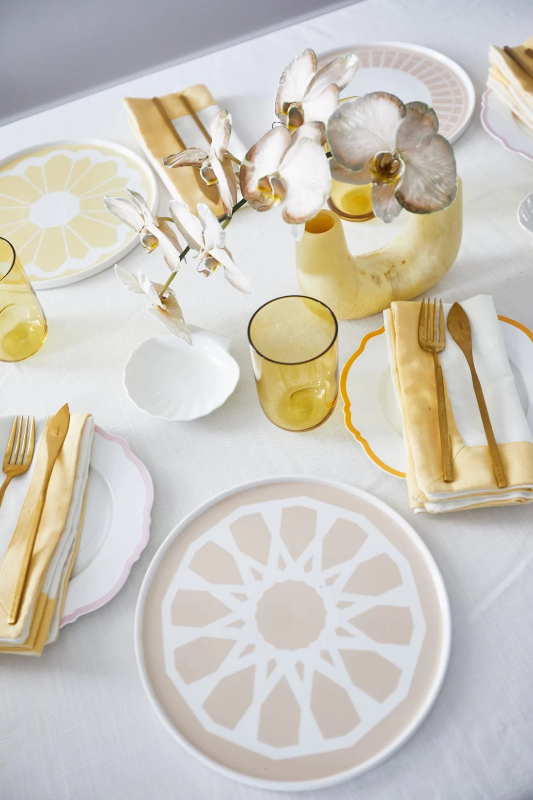Beautiful white and gold plate set displayed on a white table, the best Mothers Day gift for home-loving mums.