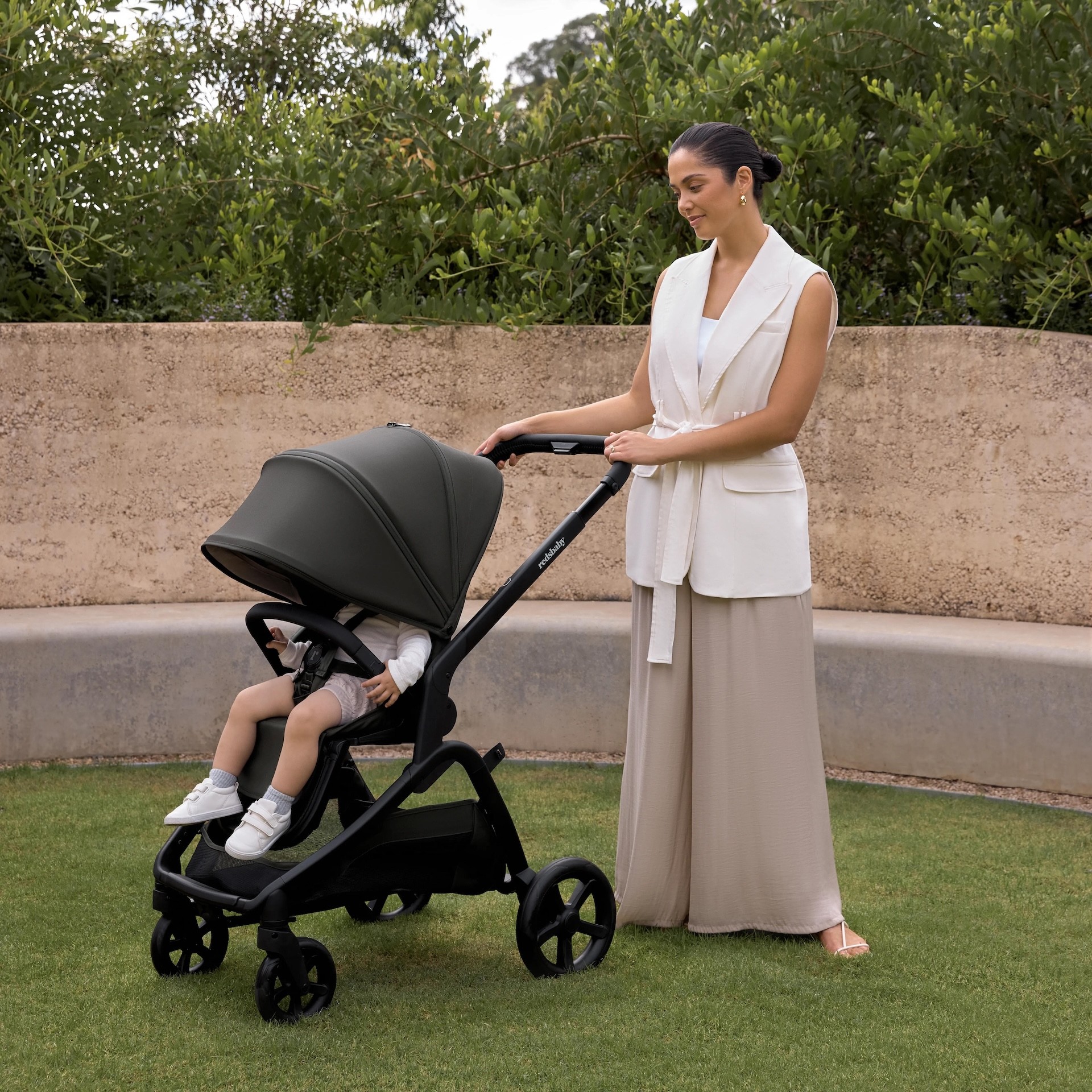 A mum standing with her baby in the redsbaby ONIX pram, one of the best prams under $999 in australia
