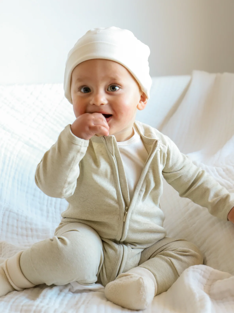 A baby in an organic zip growsuit