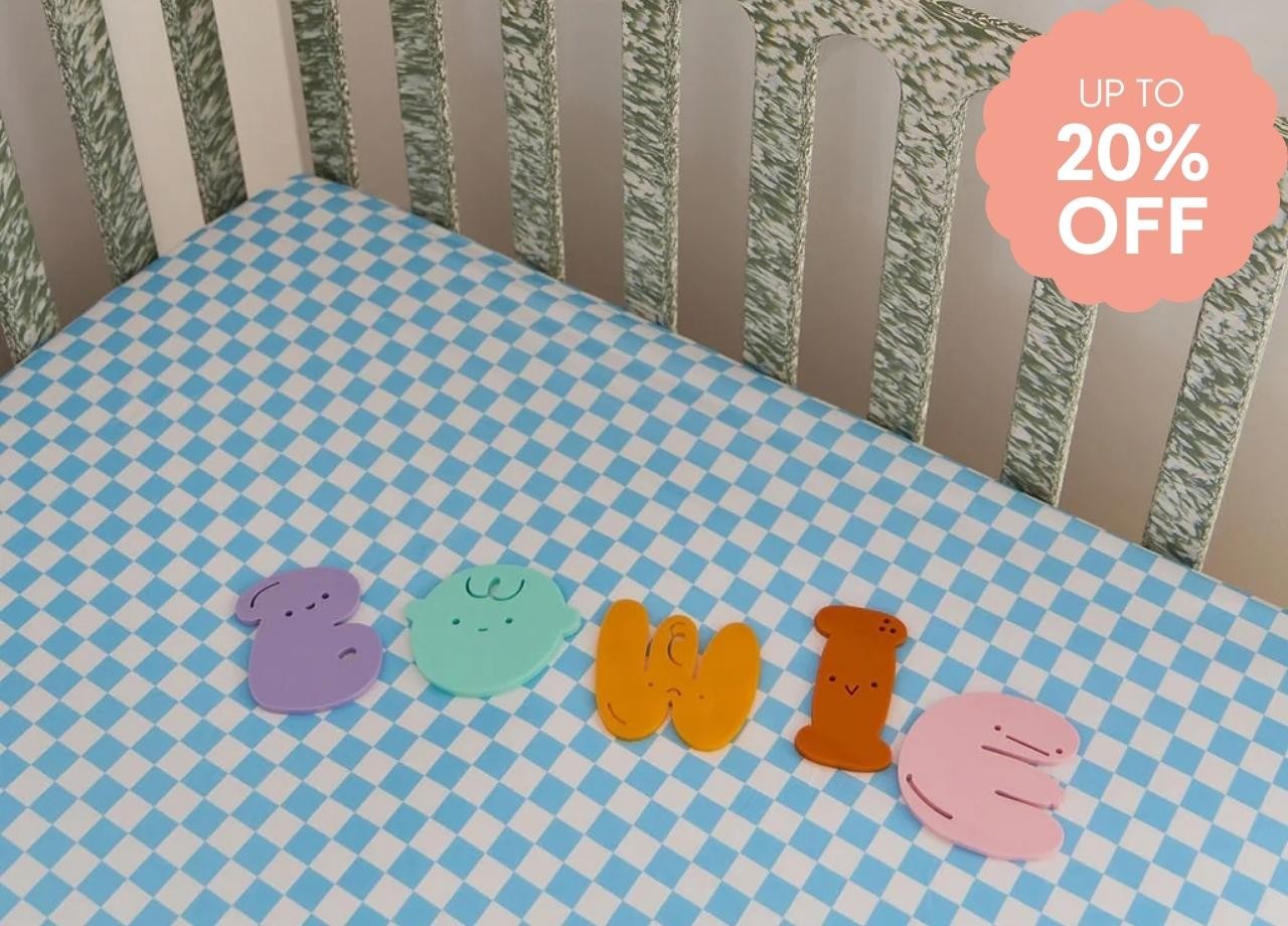 A bed with a blue checkered sheet on it