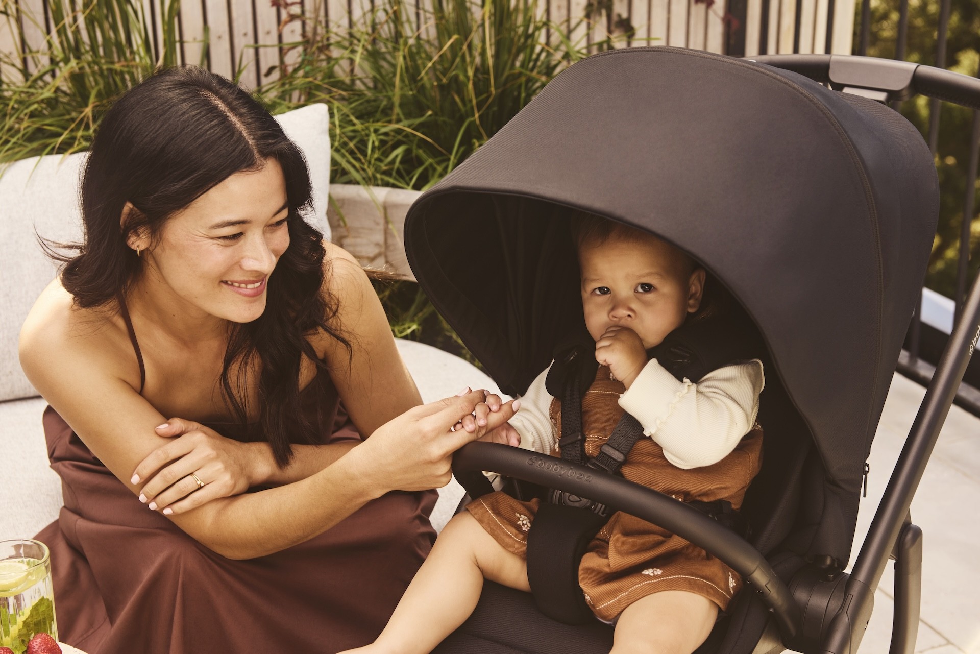 A stylish mum next to her baby in a babybee alto pram