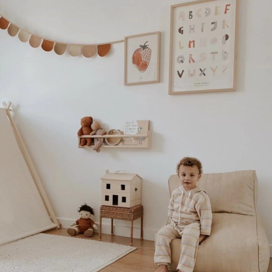 Kid relaxing on the best toddler table and chair mini lounger in a nursery, perfect for reading or playtime.
