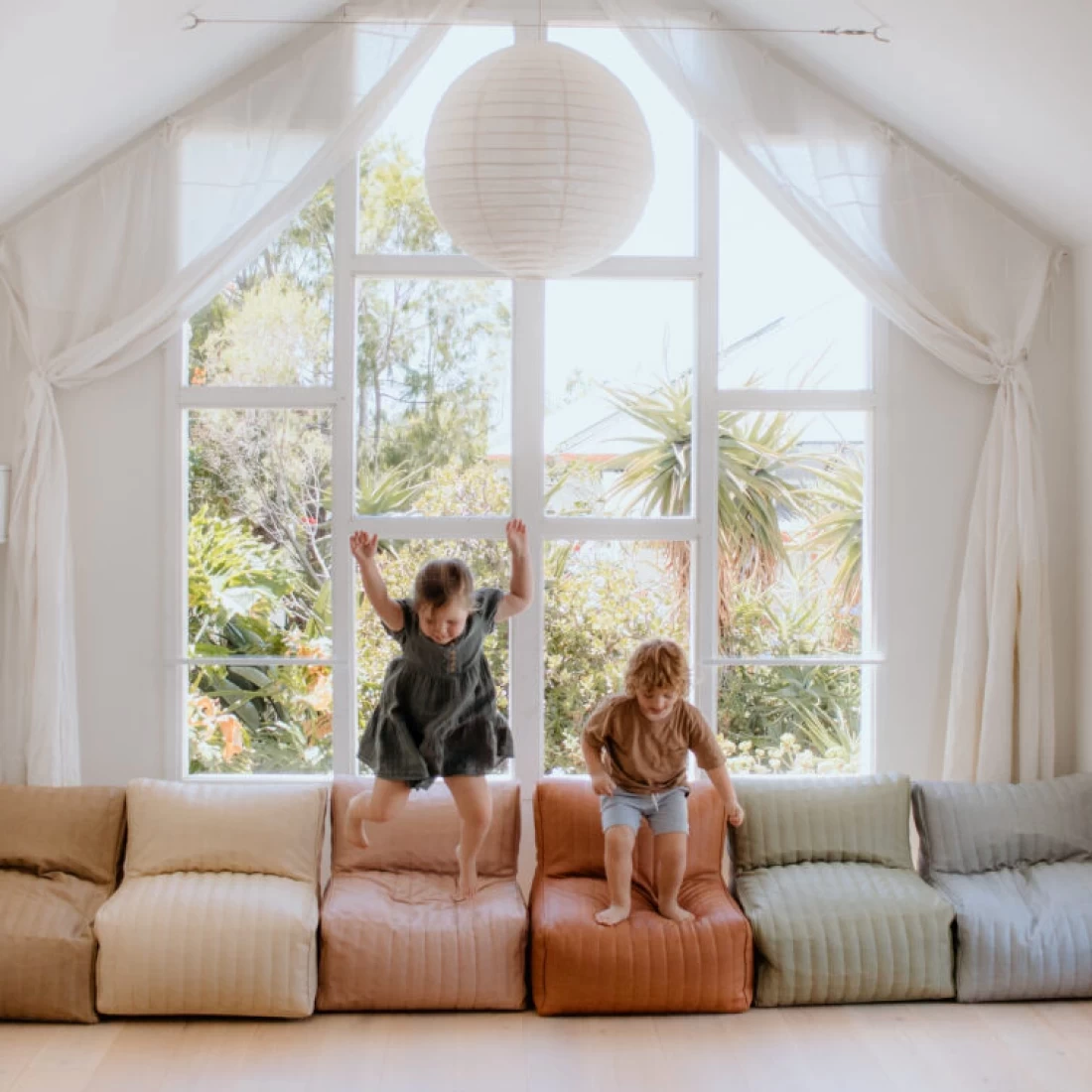 Two kids playing at the lounger, part of the best toddler table and chair set for fun and comfort.
