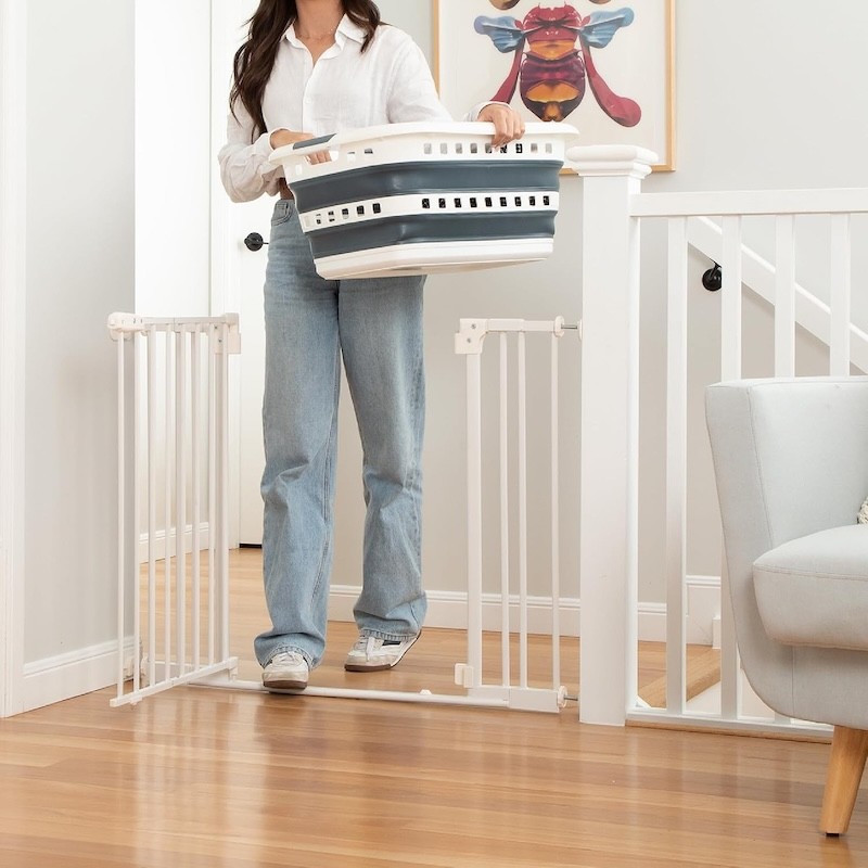 An Australian mum walking her laundry across the low step of the Perma Child baby safety gate