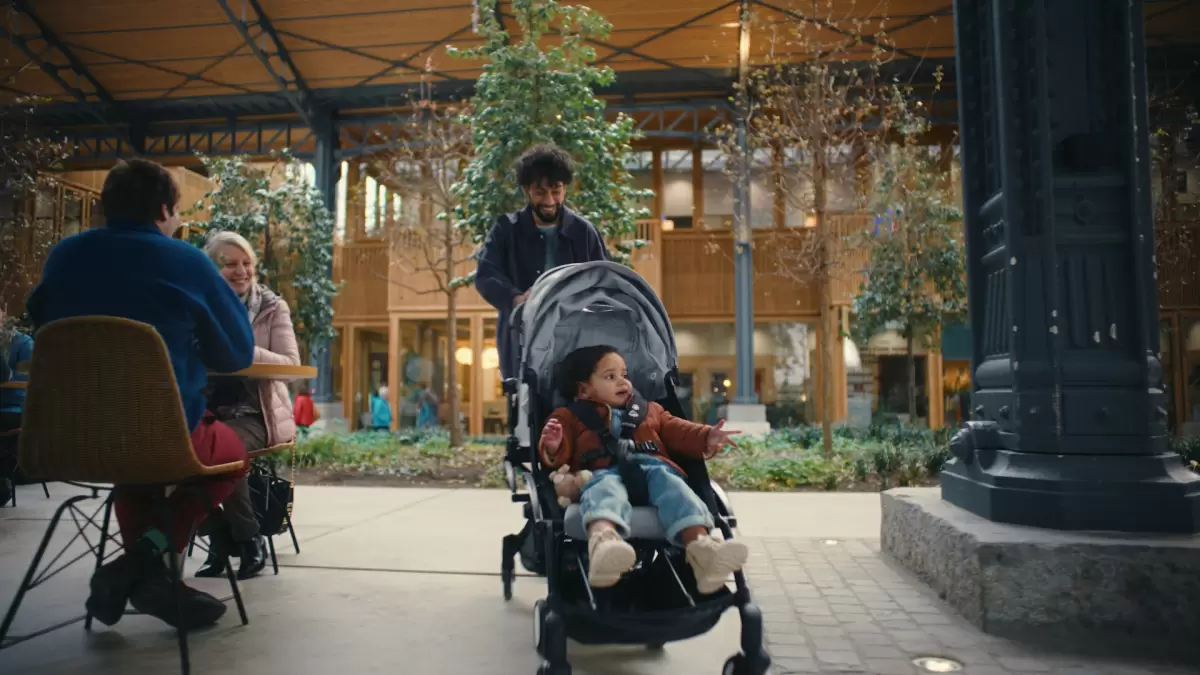 Dad and toddler walking in the Stokke Yoyo Best Travel Pram, the perfect blend of functionality and design.