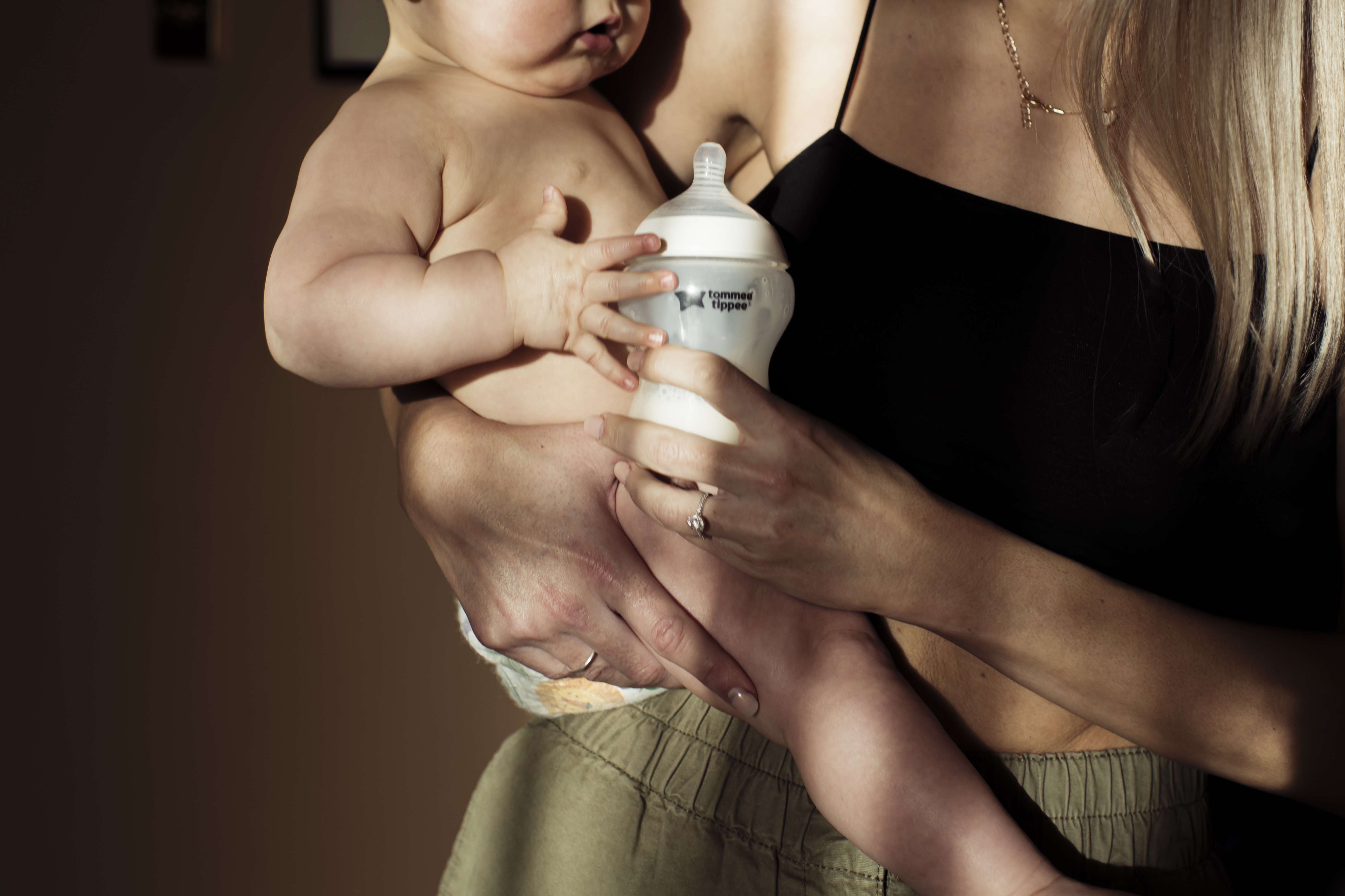 Mum with baby in arms holding Tommee Tippee Natural Start Bottle Model Lifestyle 521 best baby bottle.
