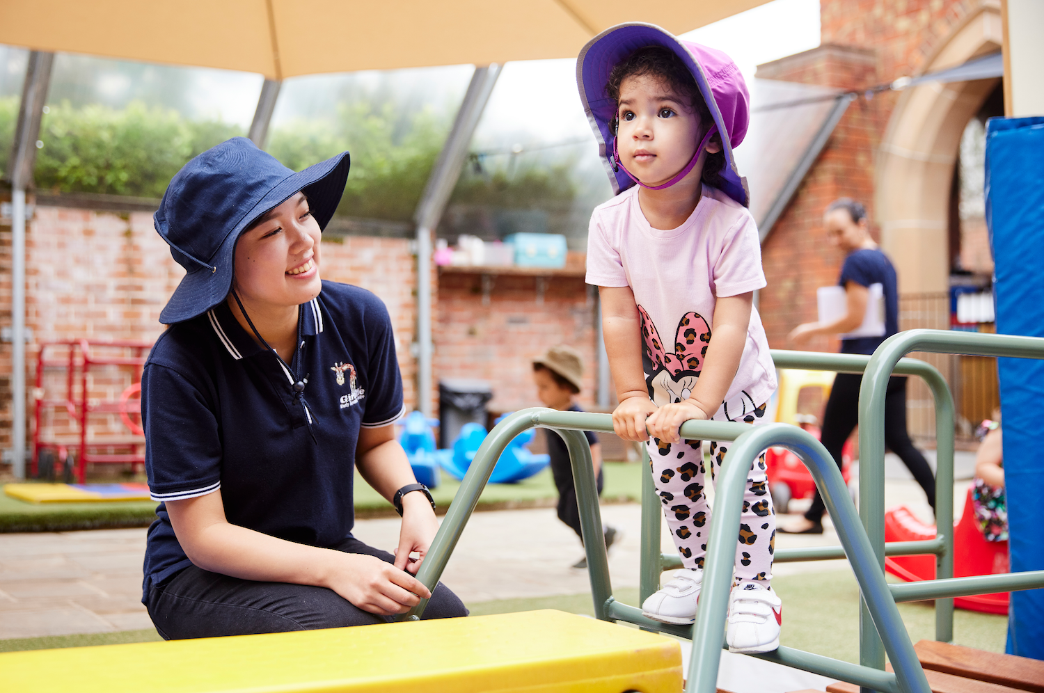 Educator playing with a toddler at the play area in the best childcare and daycare centre.