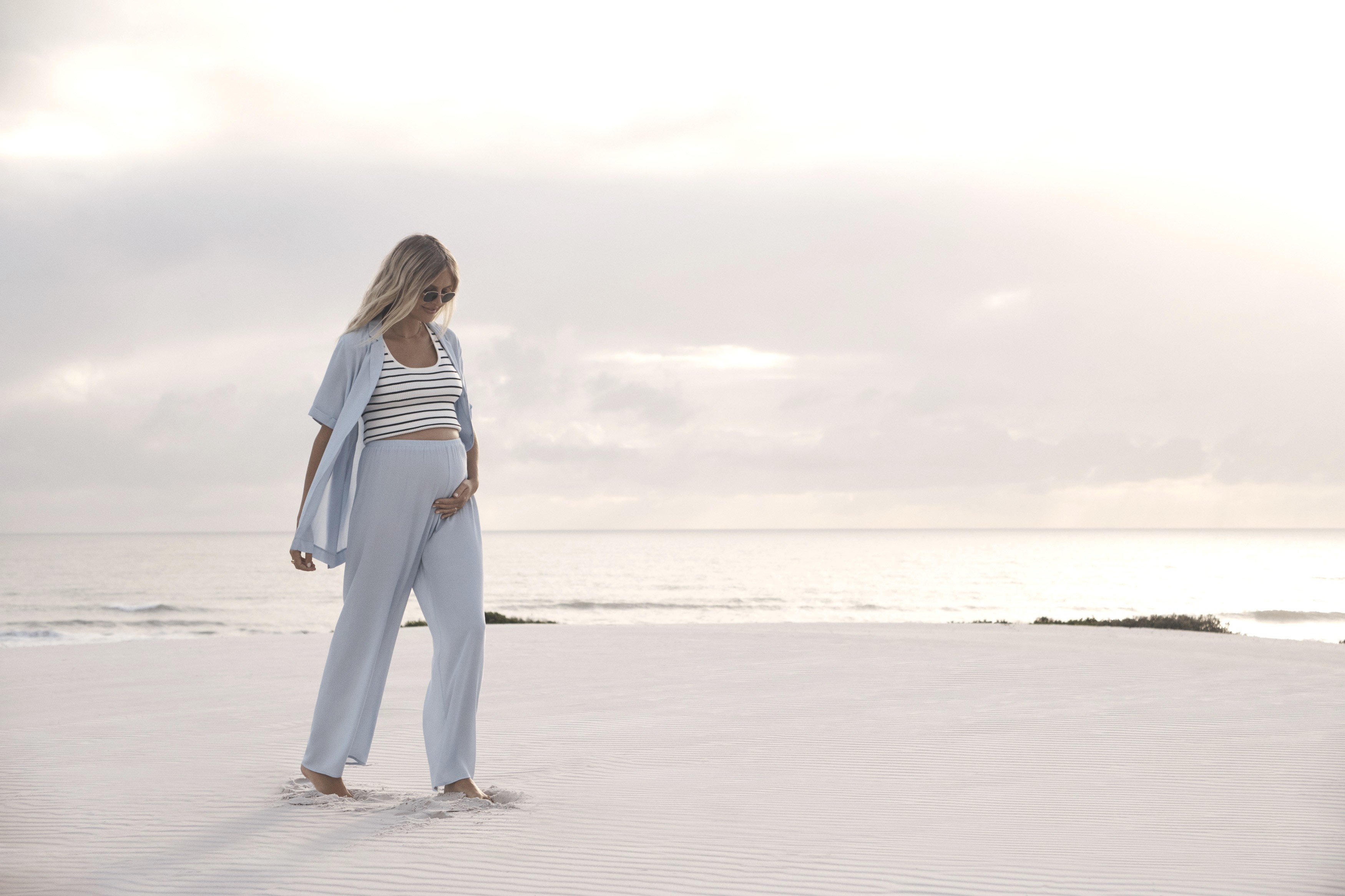 Pregnant mum outdoors wearing the Legoe Heritage Holiday Rayon Set with Sky Woodford Crop Tank in Ib Stripe, a chic pick from the best maternity clothes.