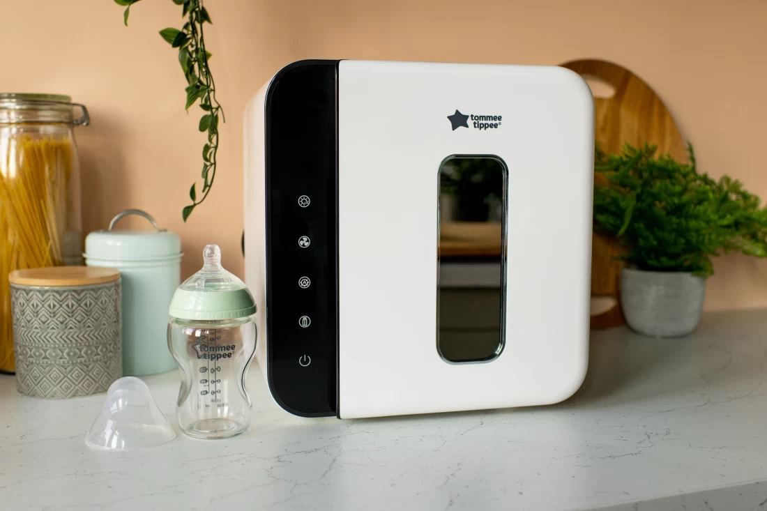 Baby bottle resting next to the Tommee Tippee Ultra UV 3-in-1 steriliser, dryer and storage – trusted hygiene solution for Australian homes