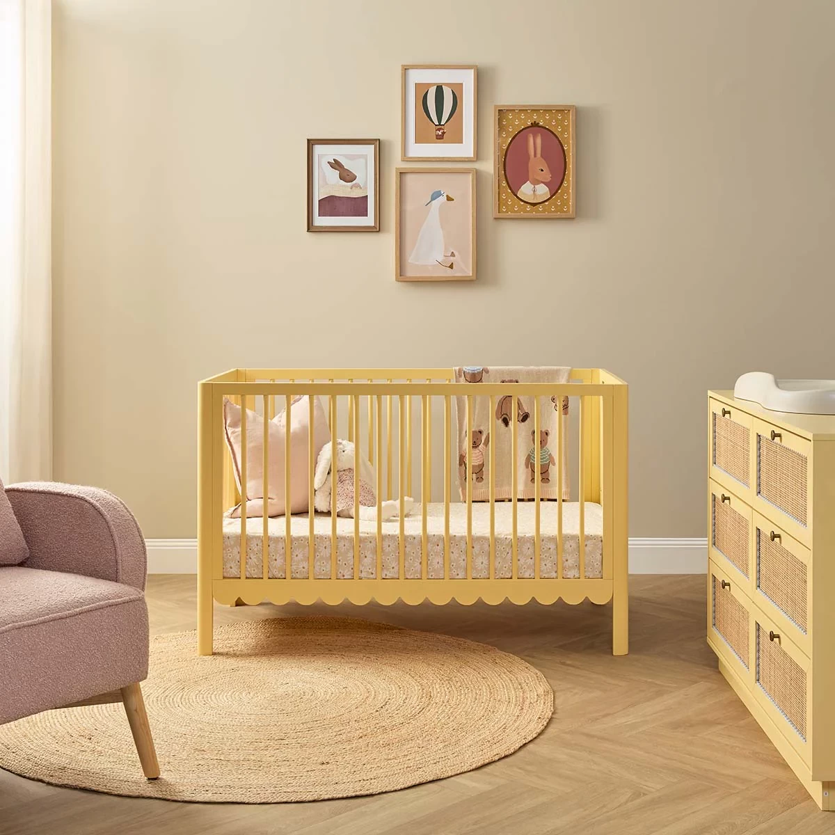 The Mocka Scalloped baby cot in yellow in a bright nursery room