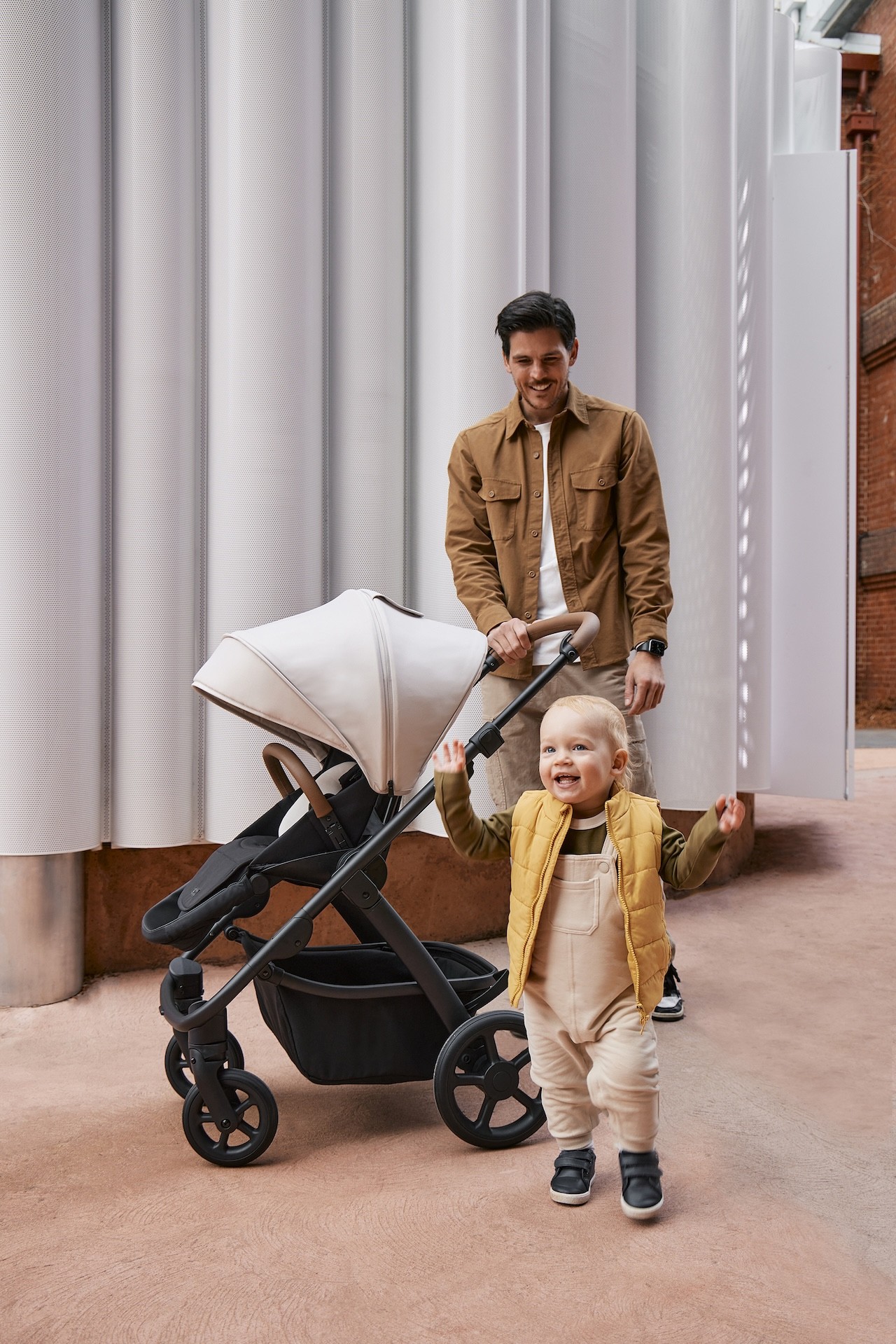 A dad with his toddler and the Milly + Coup pram