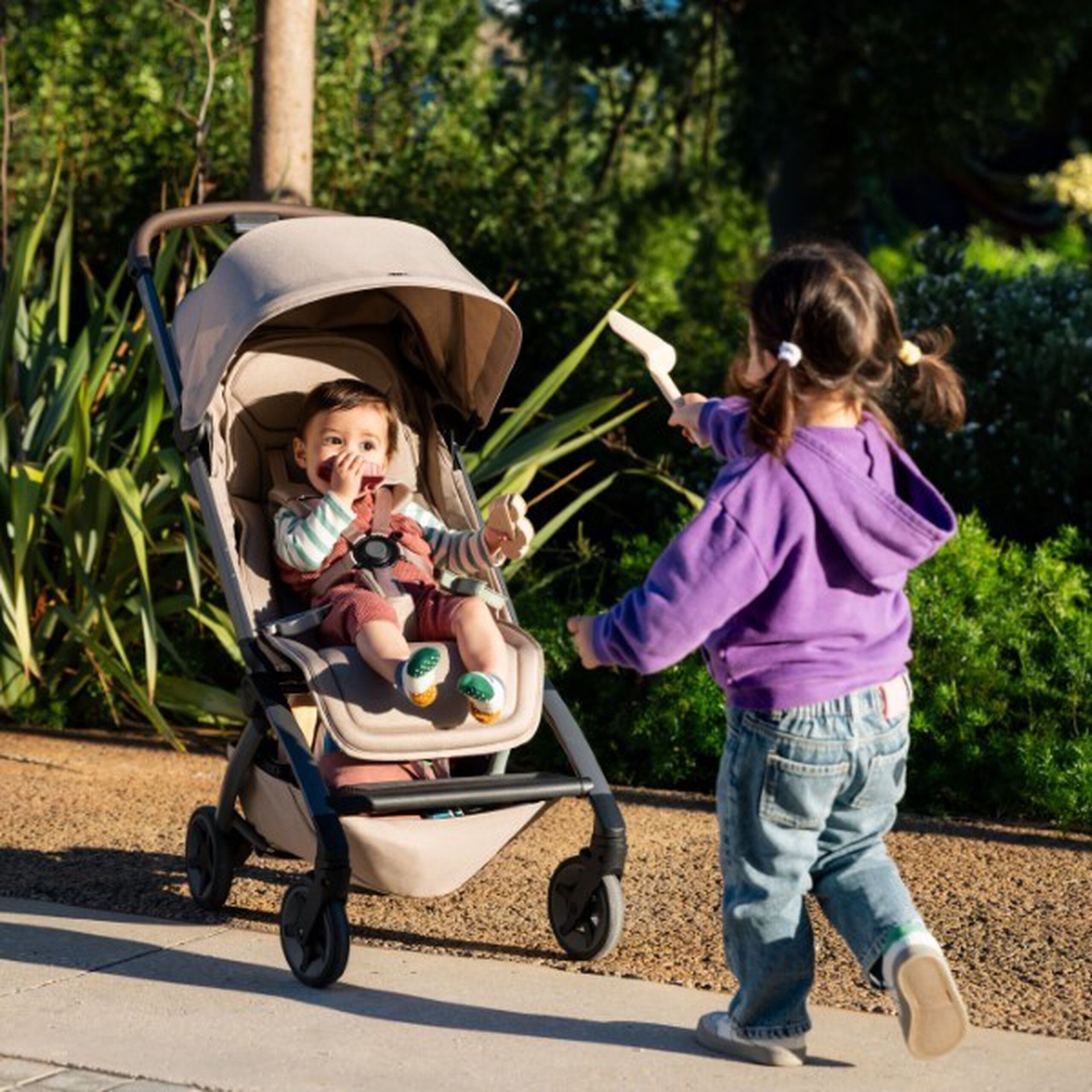 A toddler entertaining a baby in the Joolz Aer+ travel stroller in Australia