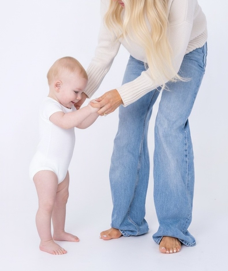 a baby walking in a White Flexisuit