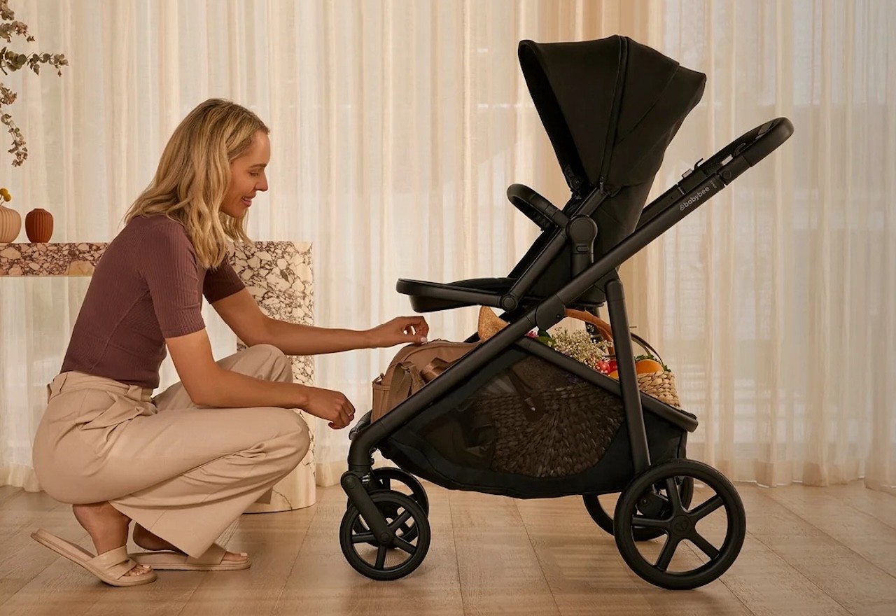 The babybee juno pram shown with a baby in it