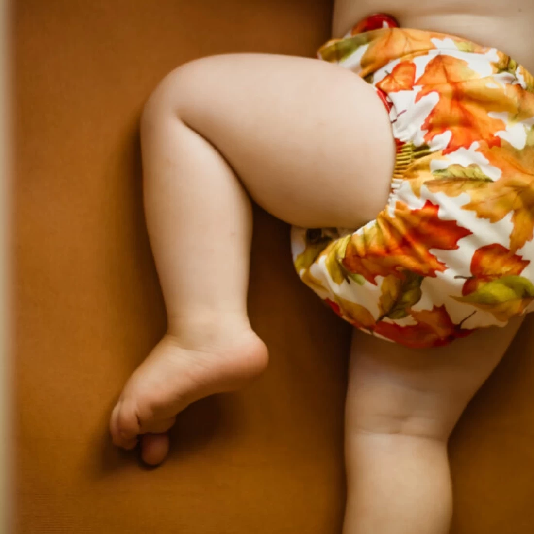 Detailed view of baby waist with best cloth nappies, showing secure fit and adjustable snaps.