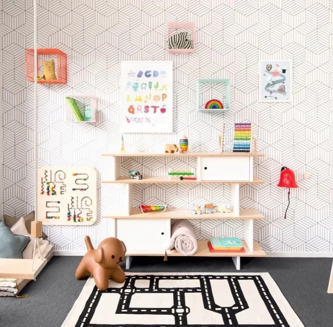 Modern nursery with minimalist white wall art, reflecting the best nursery decor trend
