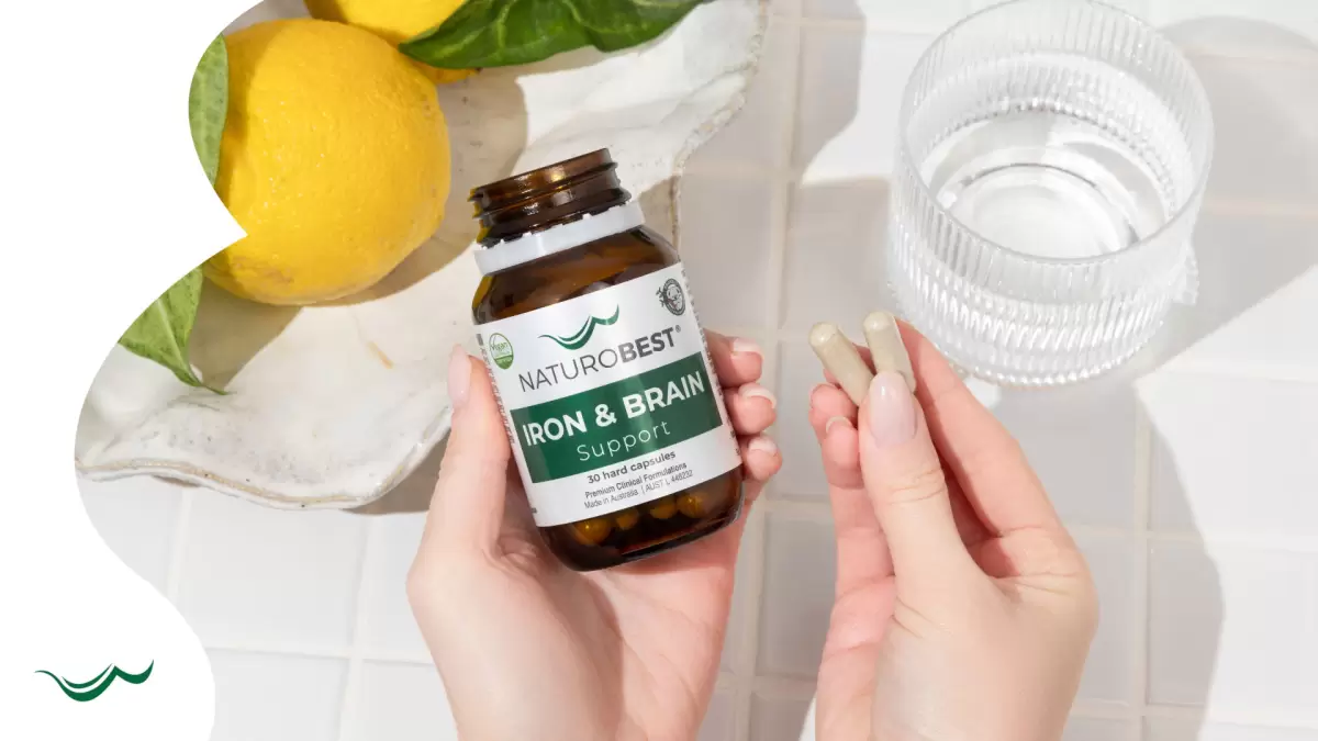 Pregnant Australian woman with NaturoBest Iron & Brain Support and two supplement pills – trusted as the best iron supplement for energy and brain health.