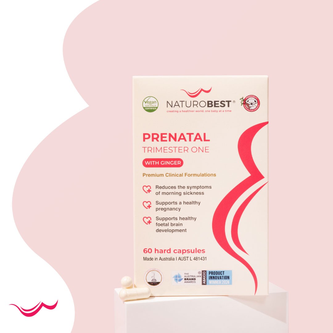 Box of Prenatal Trimester One with Ginger on tiled countertop with three capsules – trusted vitamin supplements for pregnancy.