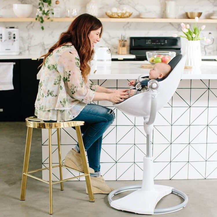A mum feeding her baby in a Fresco highchair