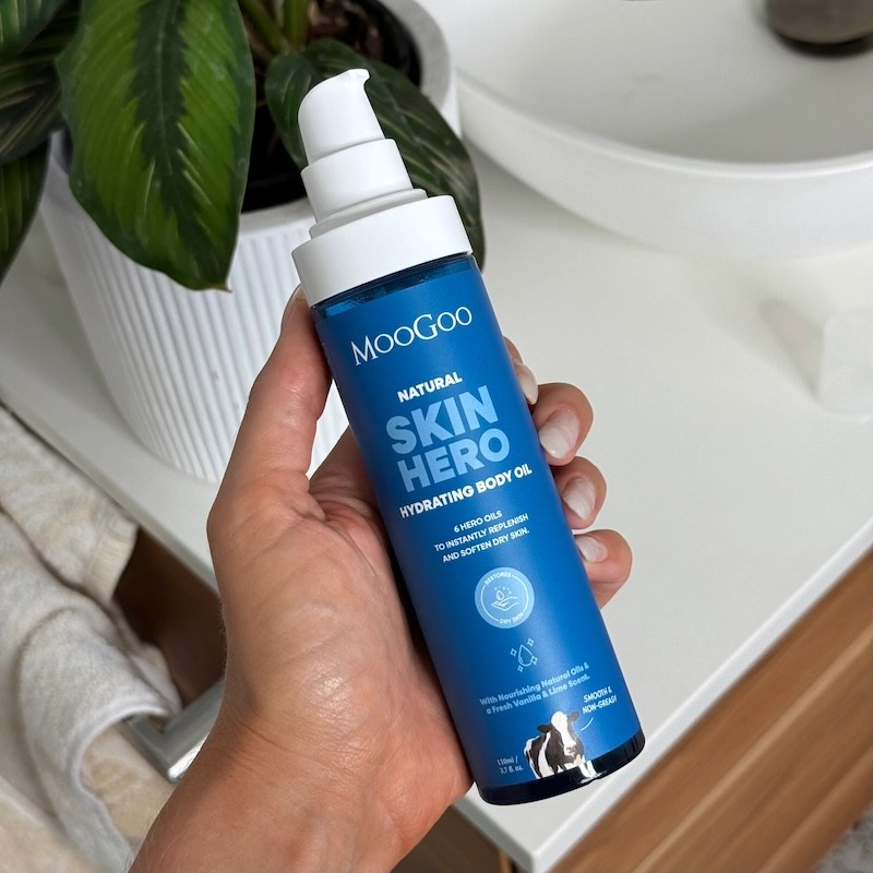 Someone holding pregnancy safe skincare brand Moogoo's skin hero body cream