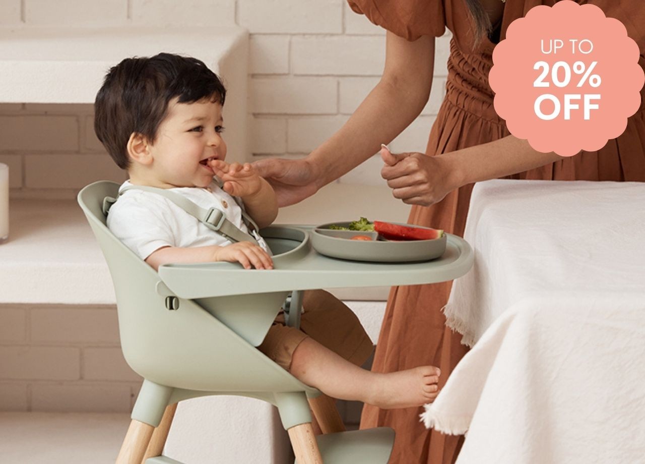 A toddler eating in a high chair
