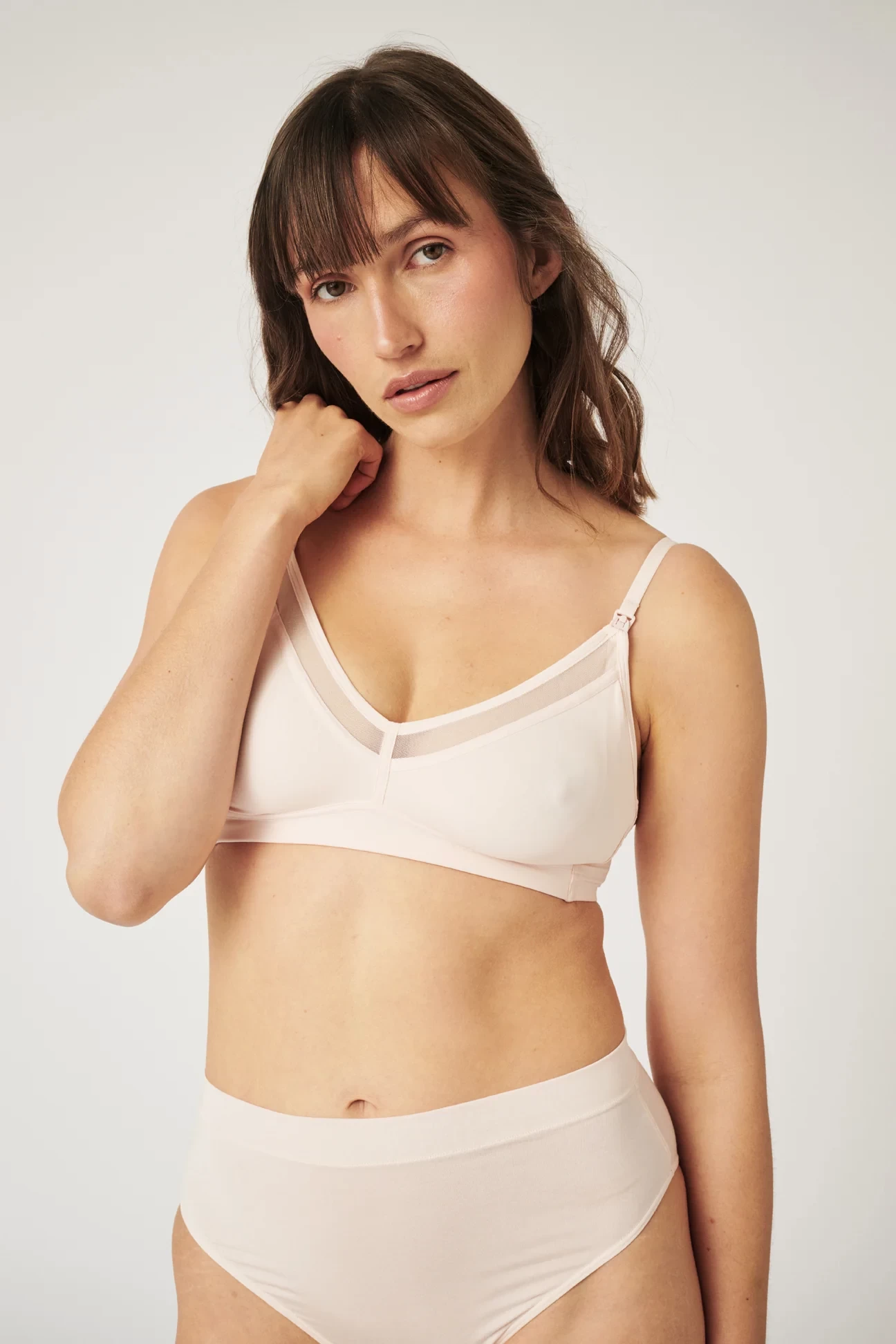 A woman wearing the first thing maternity bra