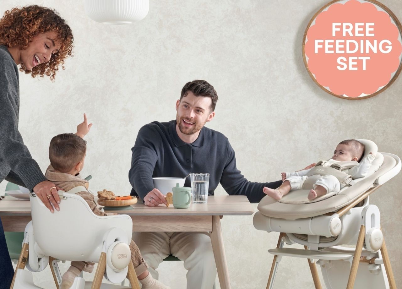 A family feeding their babies around a dinner table