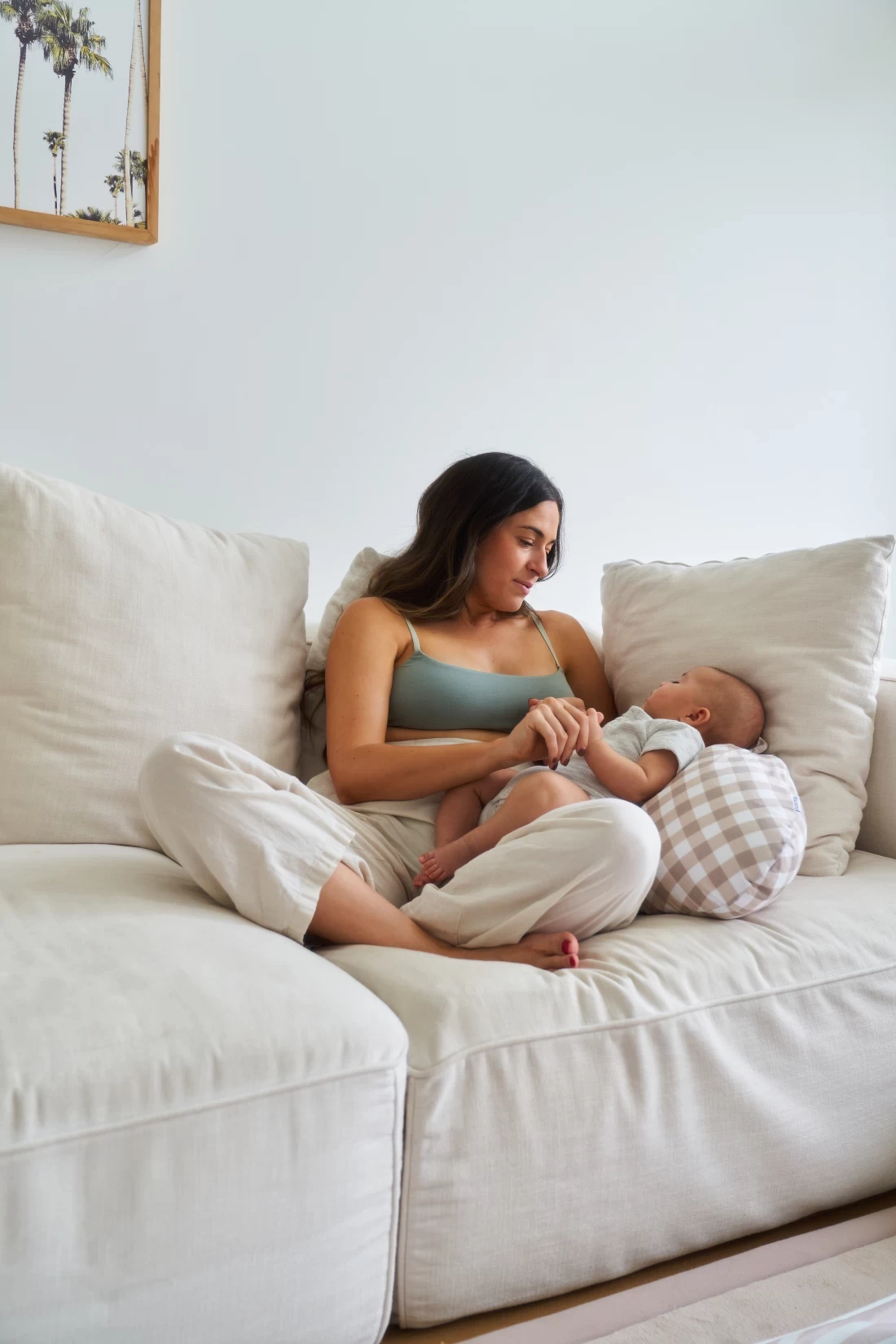 Mum playing with her baby while supported by the Butterfly Maternity Pillow – perfect for bonding and comfort.