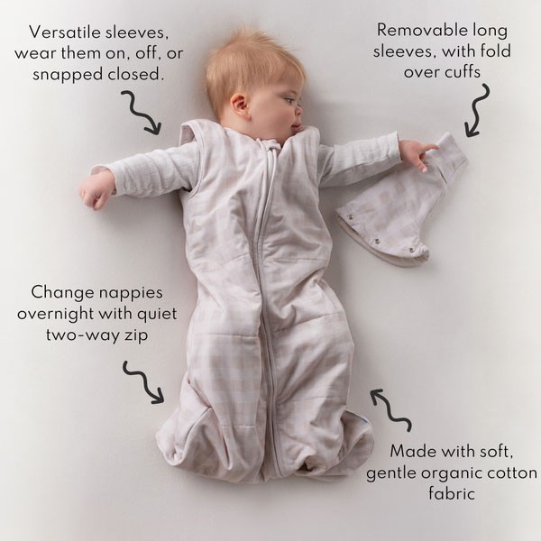 Baby lying in a light brown Sleepybelly infant swaddle sack with product features displayed around the sleepsack for safe sleep guidance