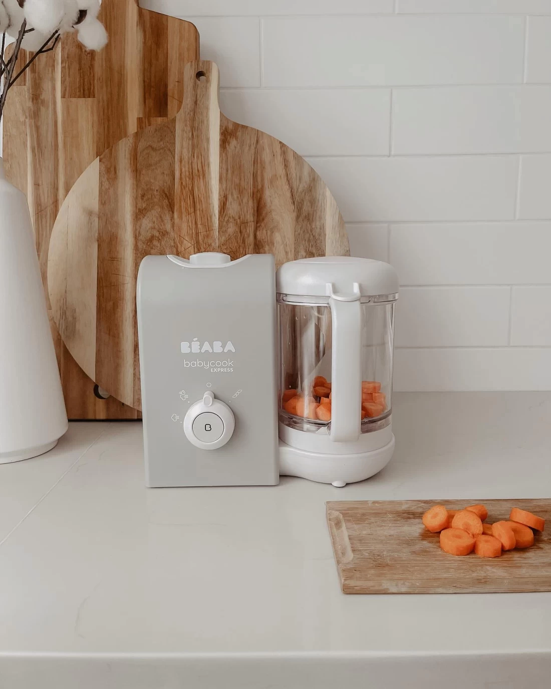 Beaba Babycook Express best baby food maker filled with sliced carrots—compact and efficient for homemade baby meals.