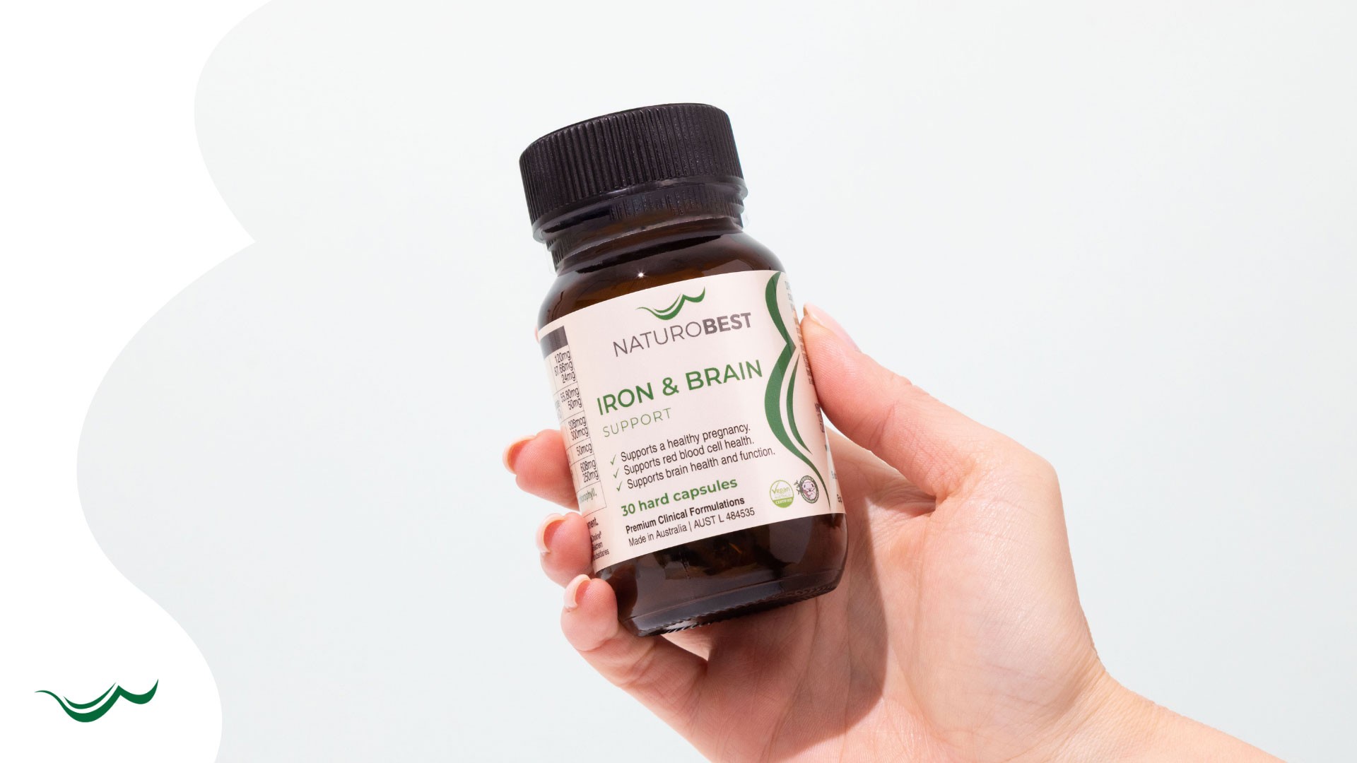 Pregnant Australian woman with NaturoBest Iron & Brain Support and two supplement pills – trusted as the best iron supplement for energy and brain health.