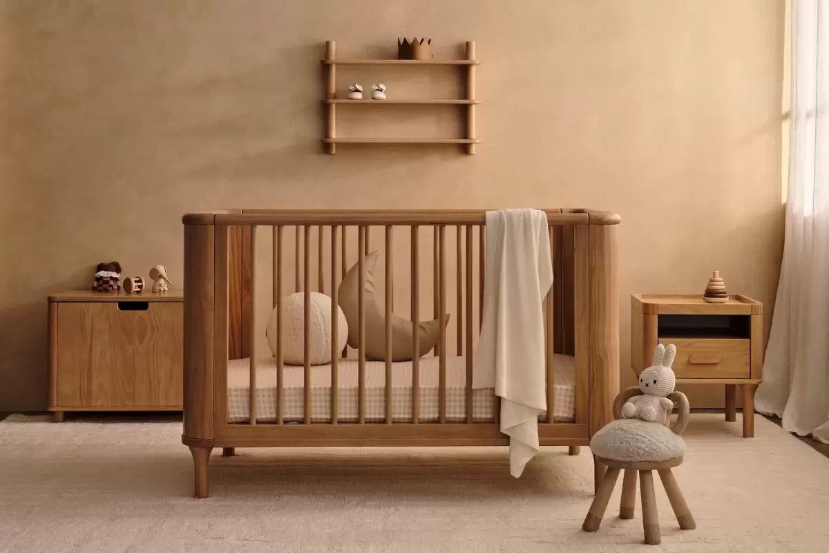 a wooden baby cot in a nursery