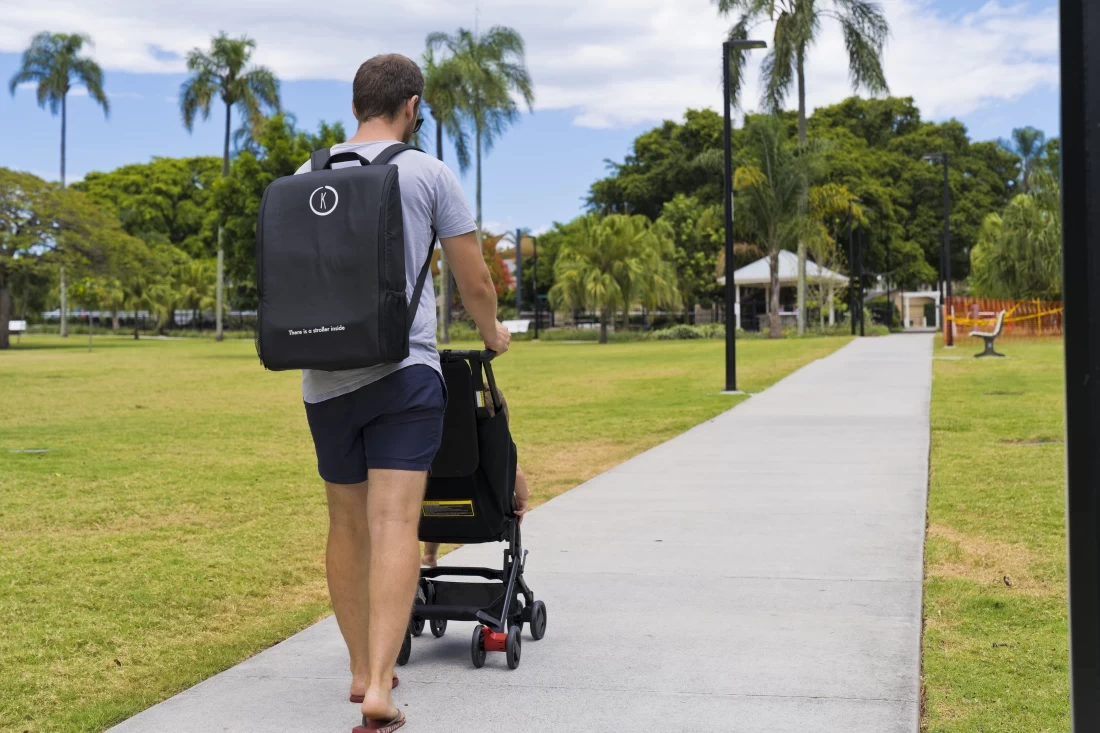 Toddler in the Karion Kids Best Travel Stroller, with dad on a stroll, offering ease and comfort for family outings