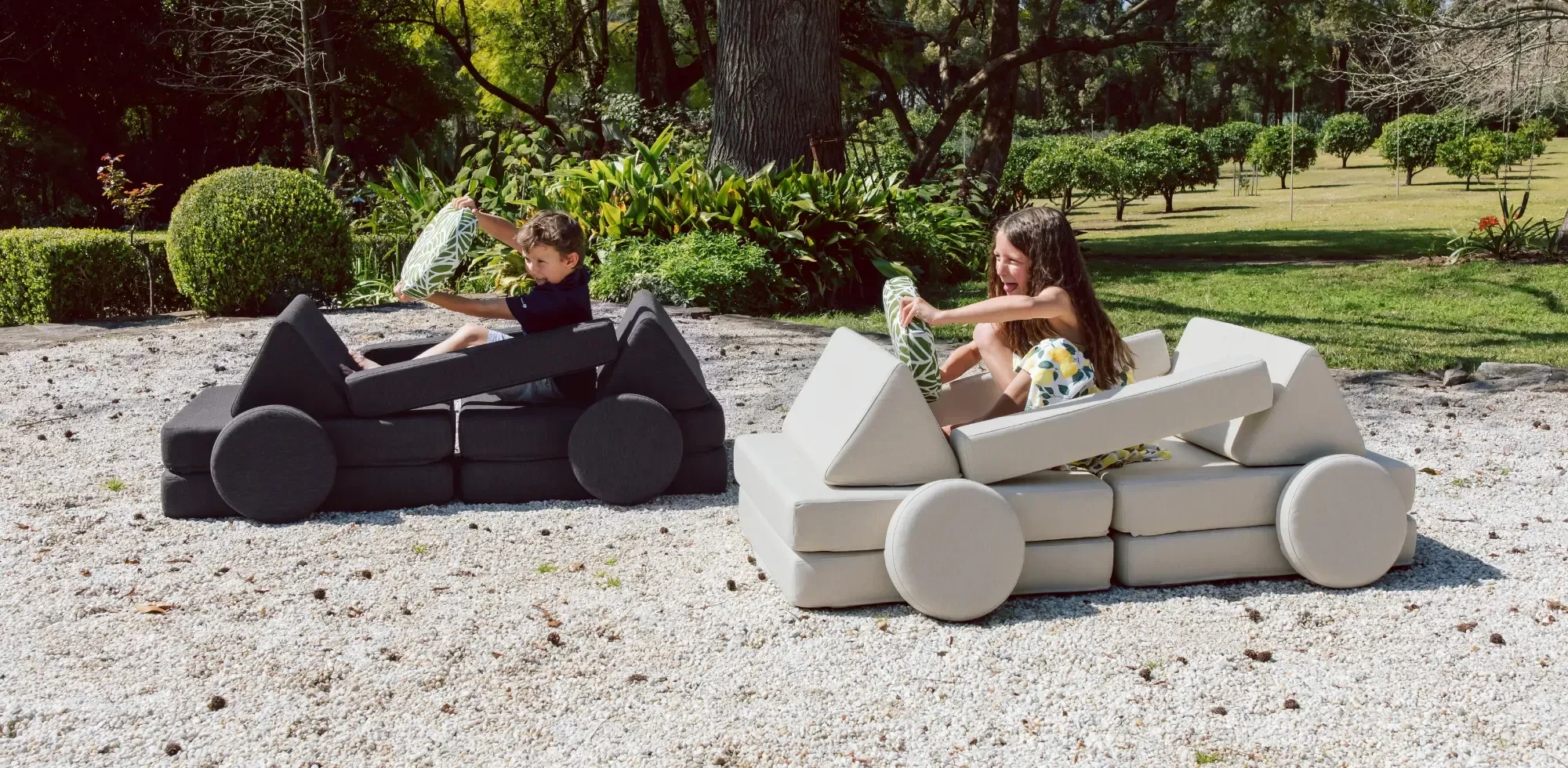 Two kids on Nook play couches made into cars