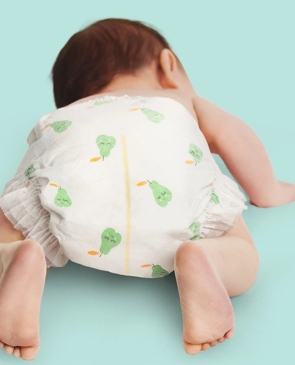 a baby in tooshies nappies