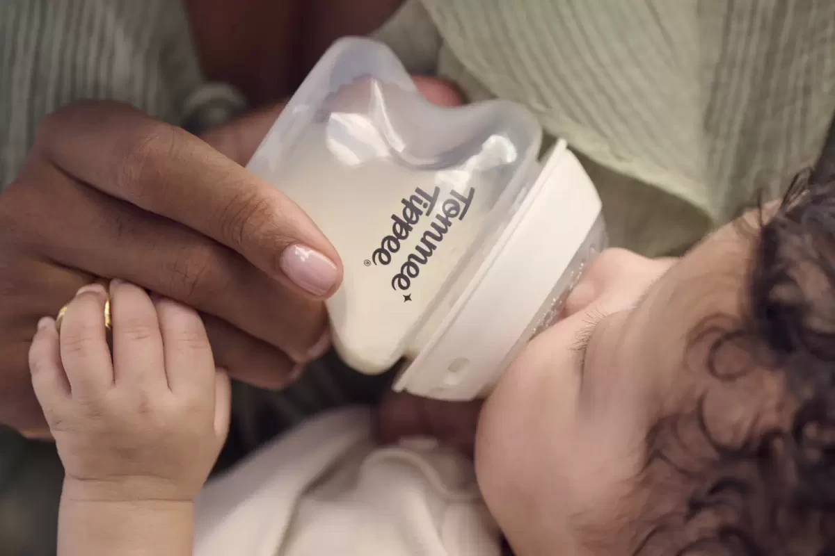 A baby feeding with a bottle, a great baby registry gift