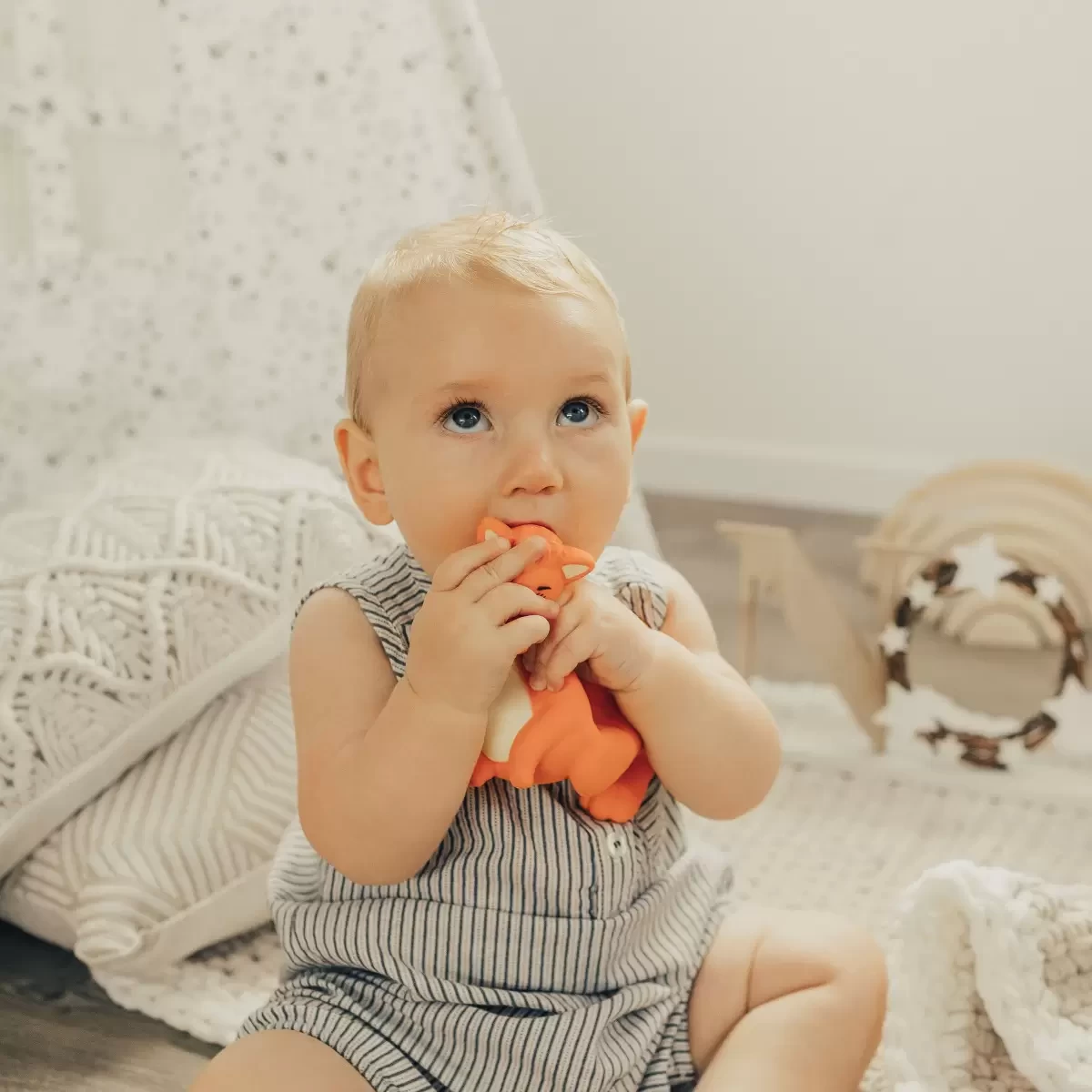 a baby using a baby teether, a great baby registry purchase