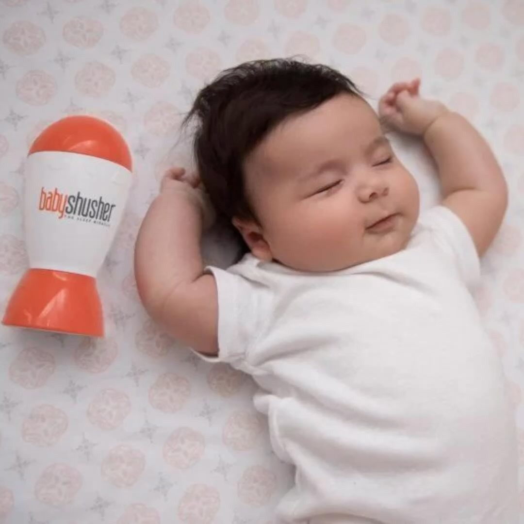 Baby shusher sleep aid helping infant sleep soundly with white noise by the bedside.