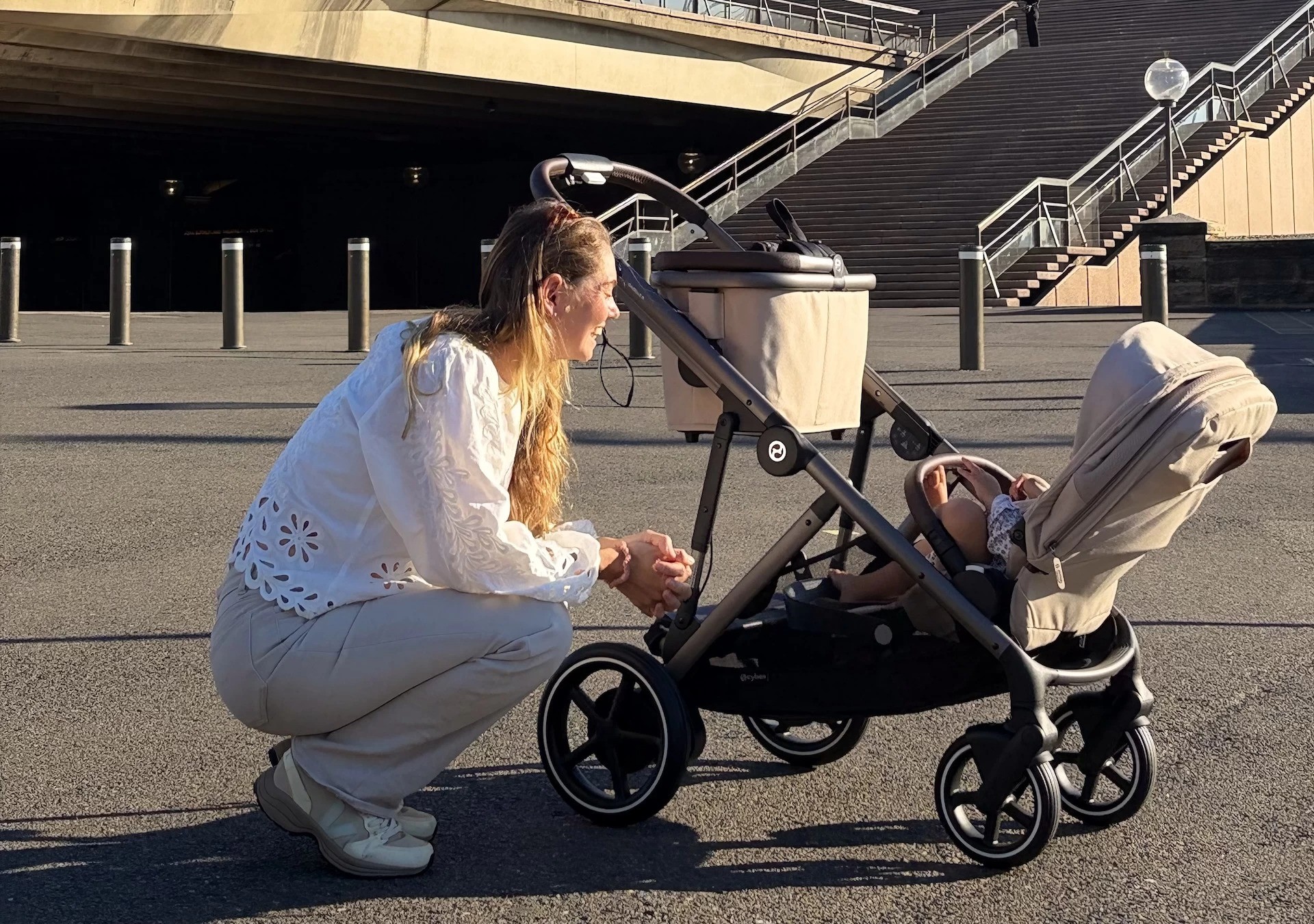 The Cybex e-gazelle s pram with a mum tending to her baby