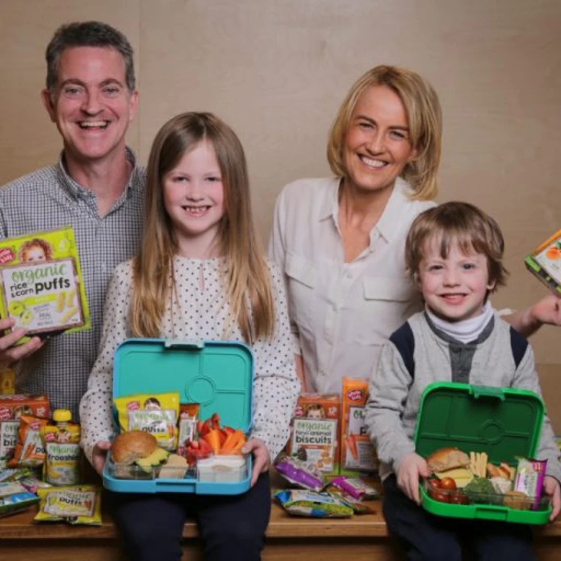 Happy family enjoying snacks together while showcasing the best baby brand choice for parents.