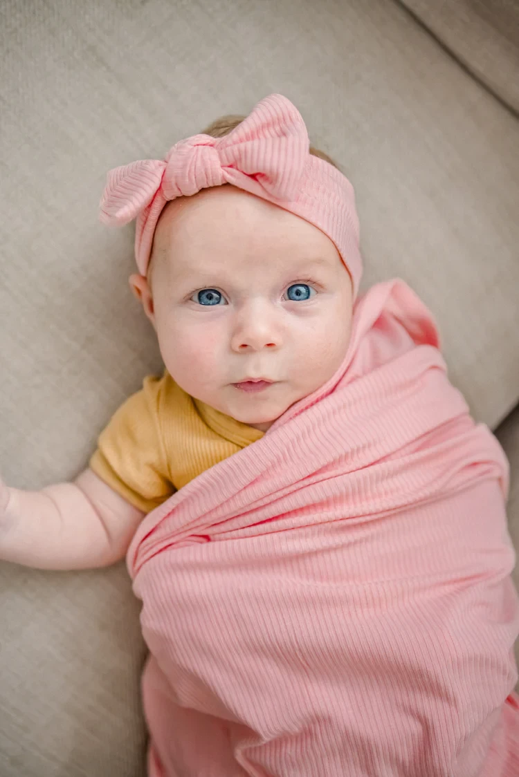 Kiin Bamboo Swaddle in pink on a baby