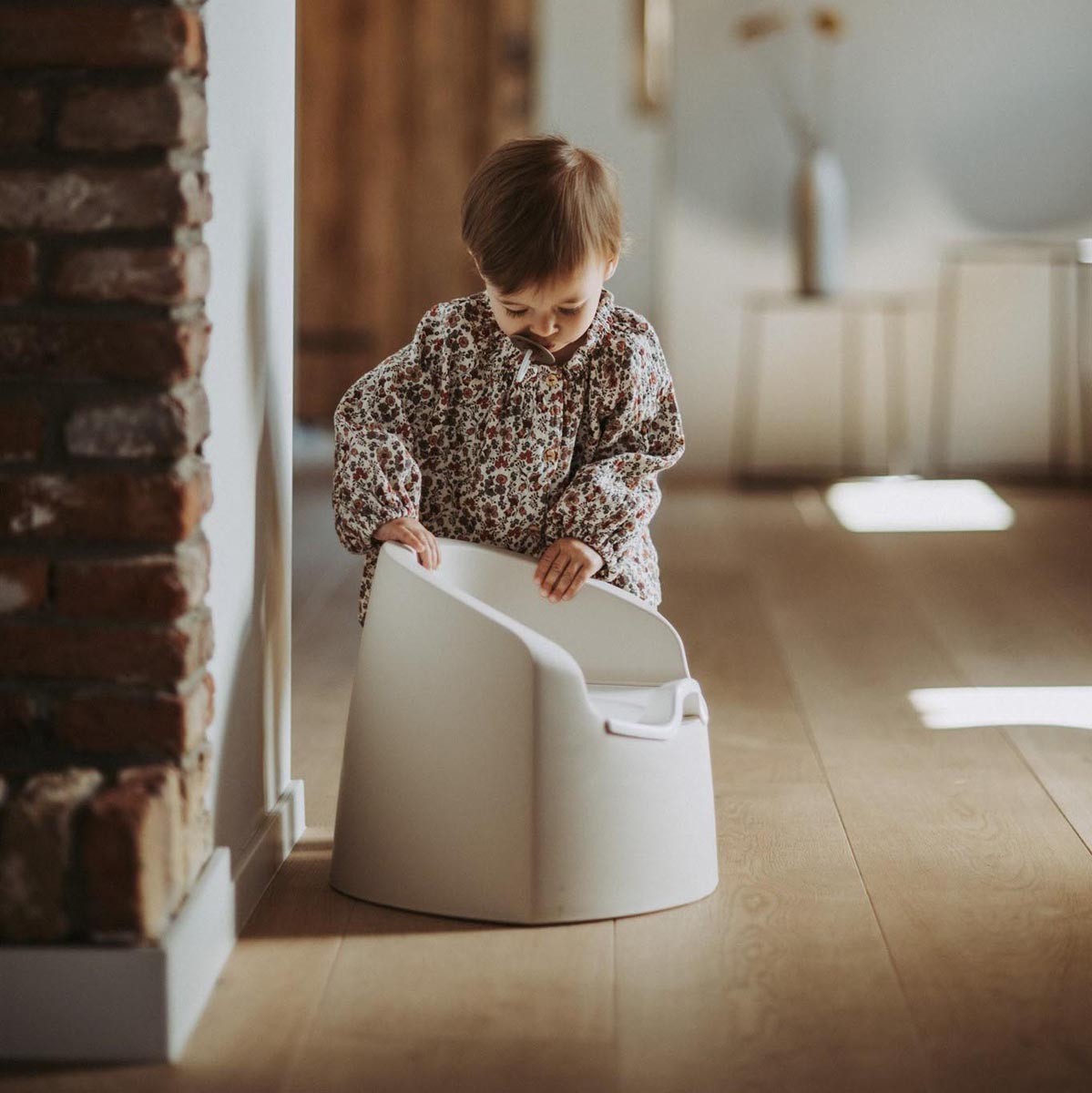 Toddler exploring a potty training seat, showcasing the best toddler potty for easy toilet learning.