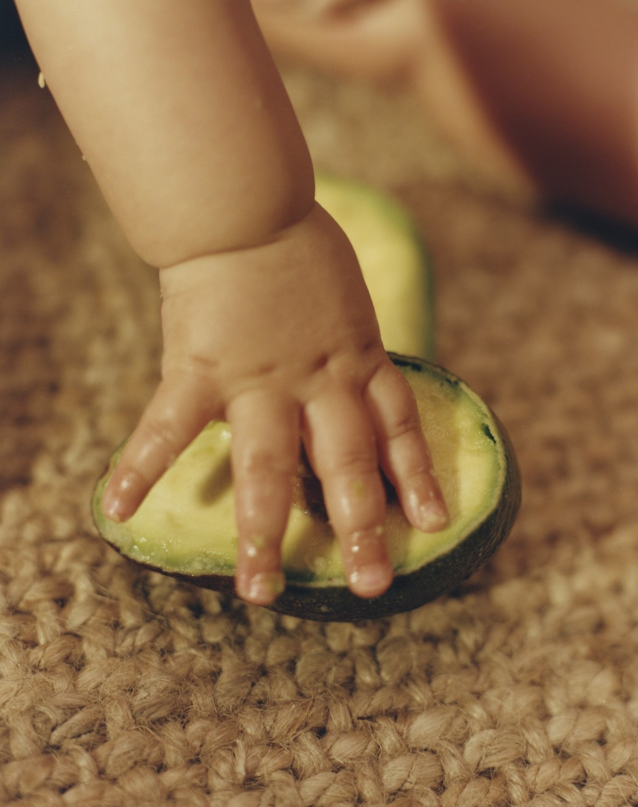 Baby with avocado