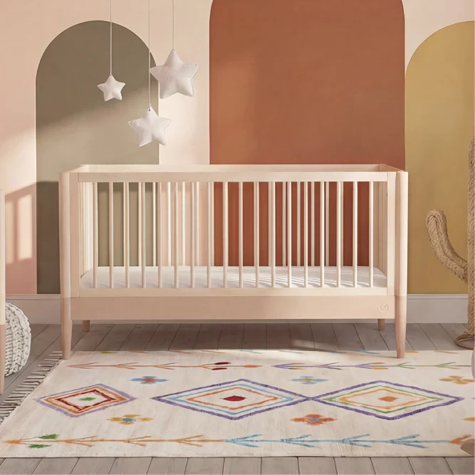 The gaia eos cot in a nursery room